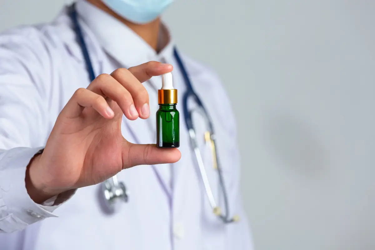 Doctor holding cannabis oil - prescription specialist UK clinic